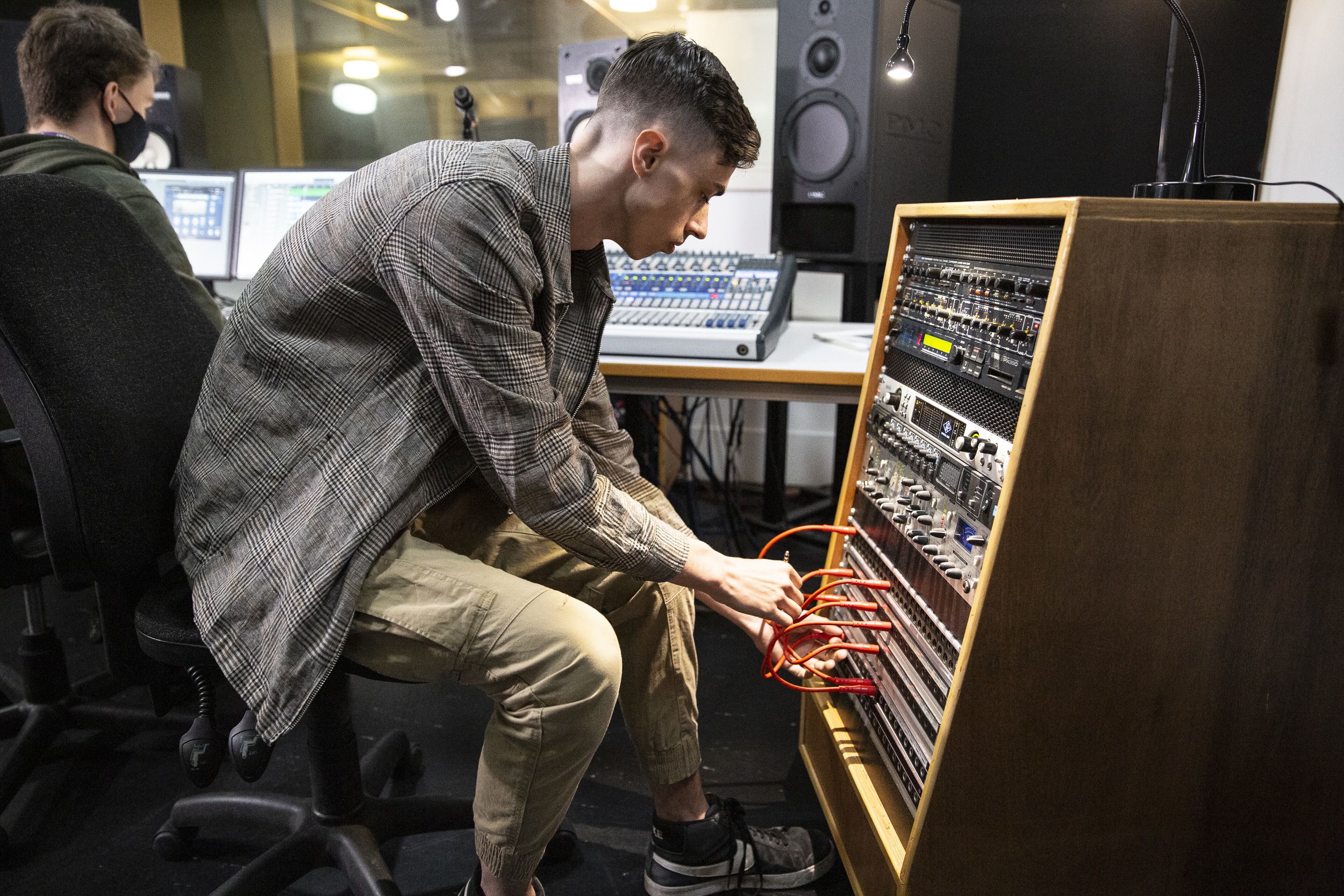 Audio Production student using an amp and sound board